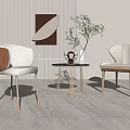 Modern Minimalist Interior With Round Small Table And Beige Chairs Decorative Painting And Green Plant