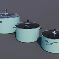 Three Light Green Cooking Pots With Black Lids And Silver Handles