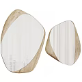 Two Irregular Shaped Decorative Mirrors With Textured Frames And Reflective Surfaces