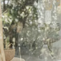 Gold Sheer Curtains In Bedroom With Natural Forest View And Wooden Blinds