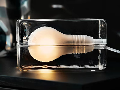 Illuminated Transparent Glass Table Lamp With Bulb Inside And Rectangular Design On Black Tabletop 3d model