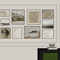 White Wall With Multiple Framed Paintings And Green Cabinet With Bowl And Books