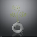 White Vase With Circular Hole Holding Green Branches In Simple Decor