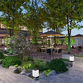 Traditional Garden Landscape With Trees Outdoor Seating Umbrellas Stone Paved Ground Greenery And Lantern Lights