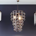 Elegant Crystal Chandeliers with Various Designs Hanging on Dark Blue Wall