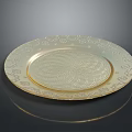 Golden Decorative Plate With Intricate Edge Patterns And Spiral Center Design