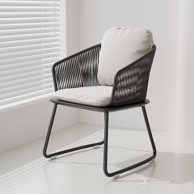 Modern Minimalist Rattan Leisure Chair With Black Frame And Light Cushion In Bright Room 3d model 