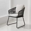 Modern Minimalist Rattan Leisure Chair With Black Frame And Light Cushion In Bright Room