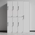 White Modern Locker Cabinet With Multiple Doors Black Handles And Locks Against Gray Wall