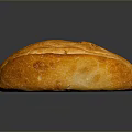 Freshly Baked Golden Bread With Cracked Crusty Surface On Black Background