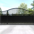 Wrought Iron Entrance Gate With White Pillars Spherical Top Decorations And Trees Blue Sky Background