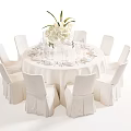 Elegant White Round Dining Table And Chairs With Tablecloth Dinnerware And Flower Arrangement