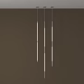Three Vertically Hanging Long Pendant Lights With White Body Metal Accents Dark Brown Background