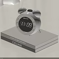 White Alarm Clock With Bells Digital Display Showing Time On Gray Box With CELINE