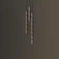 Modern Chandelier With Multiple Cylindrical White Shades Hanging Vertically In Design