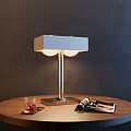 Modern Table Lamp With Square Shade Two Round Bulbs On Wooden Table With Magazines And Glass Tray