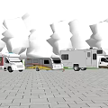 Three RVs and Pickup Truck Parked in Outdoor Area with Green Trees