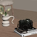 Vintage Digital Camera Placed On Wooden Table With Books White Vase And Flowers