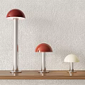 Red and White Dome Shaped Table Lamps on Wooden Shelf with Light Textured Wall