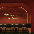 Warm Restaurant Interior With Red Curved Wall Small Lights Bar Counter And High Stools