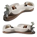 Modern Cream Curved Sectional Sofa With Decorative Pillows And Side Table Plant