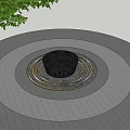 Garden Ornament With Central Water Feature And Circular Paving Around Tree