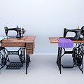 Two Vintage Singer Industrial Sewing Machines With Wooden Tables Metal Frames And Colored Fabrics