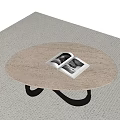 Minimalist Oval Wooden Coffee Table With Black Curved Legs And Open Magazine On Beige Carpet