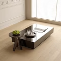 Modern Black Coffee Table With Glass Cups Magazine And Small Round Table In Bright Room