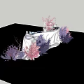 Elegant Floral Display Setup With White Tablecloth And Purple Pink Plants