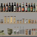 Various Glass Spice Bottles And Jars On Layered Kitchen Storage Shelves