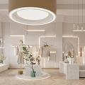 Modern Clothing Store Interior With Hanging Apparel Racks Pendant Lights Sofa And Green Plants