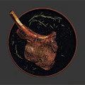 Juicy Grilled Lamb Chop On Black Plate With Rosemary And Sea Salt Garnish