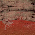 Natural Weathered Rocky Terrain With Red Sandy Ground And Scattered Small Stones