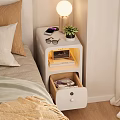 Bedside Table With Orange Lamp Alarm Clock Mobile Phone Books Cups And Drawer In Bedroom