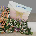 Envelope Shaped Art Installation With Colorful Floral Decorations And Yellow Bow
