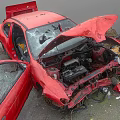 Red Damaged Car With Crashed Front End Open Hood And Broken Glass