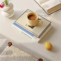 Books Magazine Stack Featuring Yellow Coffee Cup Lemon And Chocolate On White Table
