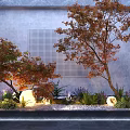 Garden Ornament Featuring Red Maple Tree Gray Perforated Wall Pebbles Purple Flowers Glowing Sphere and Ferns