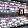 Elegant Wine Cabinet With Tiered Shelves Various Wine Bottles Glass Goblets And Illuminated
