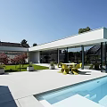 Modern Detached Villa With Large Glass Facade Swimming Pool And Outdoor Yellow Dining Set