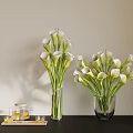 White Calla Lilies in Glass Vases on Black Table with Teapot Glasses and Light Wall