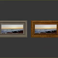 Two Photo Frames With Silver And Wooden Borders Displaying Seascape Sunset Photos On Reflective Surface