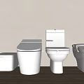 Different Styles Of White Toilets Arranged Against Light Colored Wall With Wooden Floor