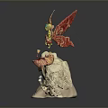 Fantasy Character Model With Red Wings Golden Details On Rock Base And Small Pink Figure
