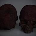 Human Skull Sculptures Carved With Dark Red Textured Surface Front And Side Views 3d model
