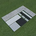 Geometric Pattern Ground Laid Out With Various Colored Stones On Green Grass
