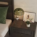 Bedside Table With Green Lamp Astronaut Figurine Flower Vase And Framed