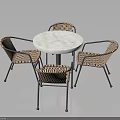 Round Marble Top Table With Four Rattan Chairs And Metal Frames