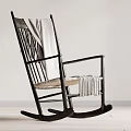 Black Rocking Chair With Light Blanket And Woven Seat In Minimalist Room